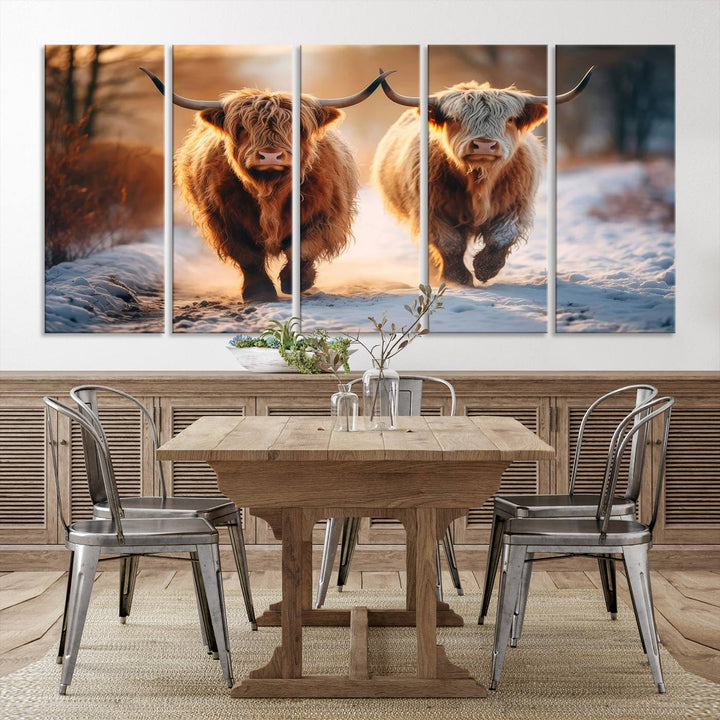 The wall art is a Scottish Highland Cow Horn canvas print featuring cows on a snowy path bathed in warm sunlight, serving as a rustic decor piece.