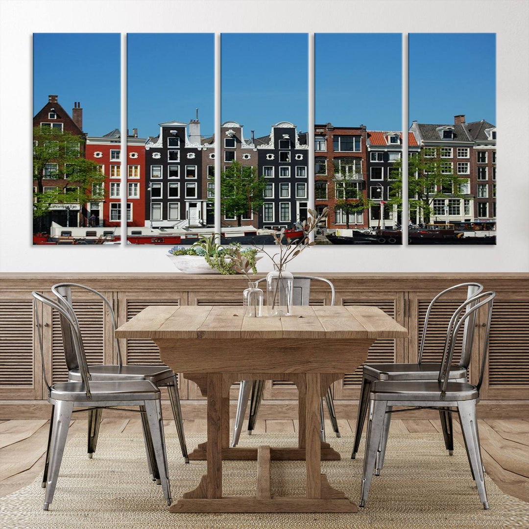 The Amsterdam City Wall Art Canvas Print showcases colorful traditional canal houses and boats set against a clear blue sky.