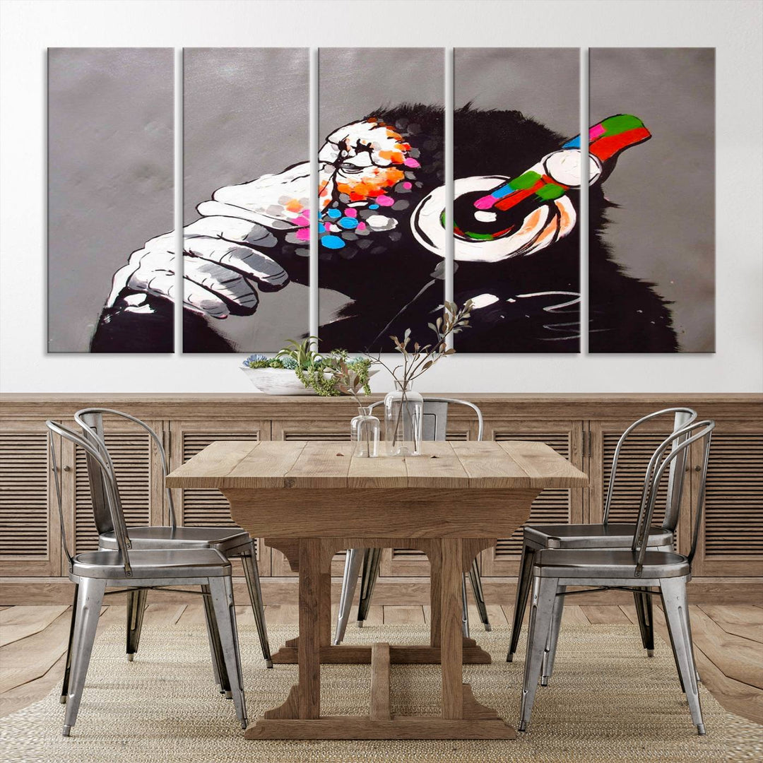 A vibrant triptych, the "DJ Monkey Listening to Music" wall art print, features a Banksy-inspired large canvas adorned with colorful modern pop art. This striking piece elegantly enhances the room with its dynamic and lively depiction.