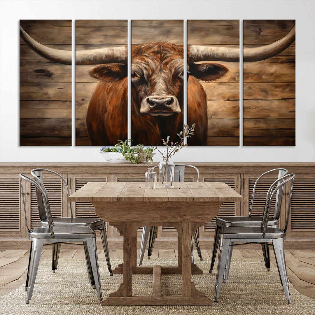 The Longhorn Bull Wall Art, a ready-to-hang canvas print, showcases an image of a brown longhorn cow set against a wooden background, perfect for those looking to enhance their space with rustic farmhouse and western barn decor.