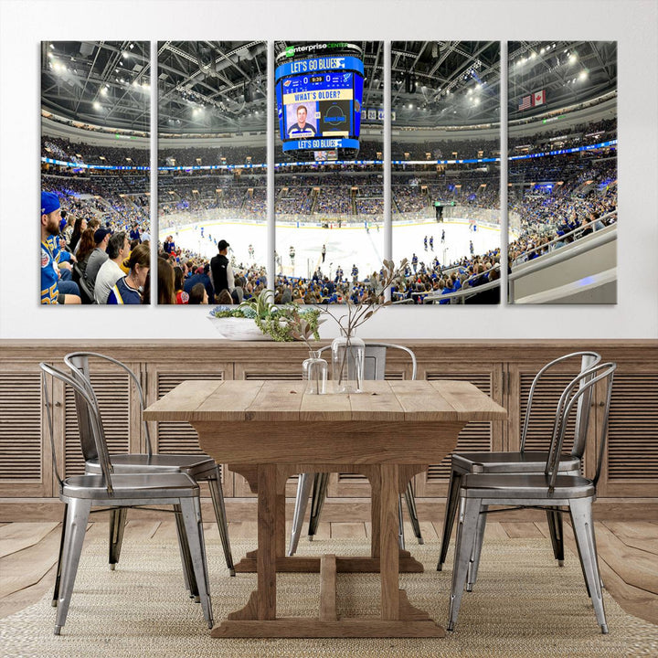 Wall art prints depicting the bustling scenes of the St. Louis Blues being cheered on by a full house at the Enterprise Center, beneath a large scoreboard.