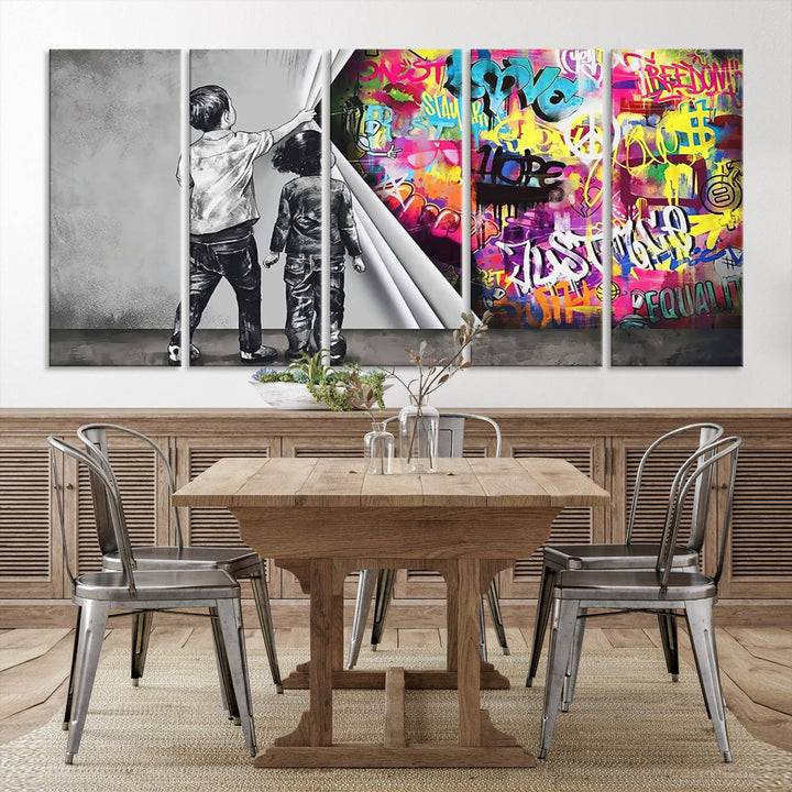 The Banksy Print - Street Art Canvas features a vibrant and bold image of two children lifting a curtain to reveal colorful graffiti. It's ready to hang, adding an urban modern decor vibe.