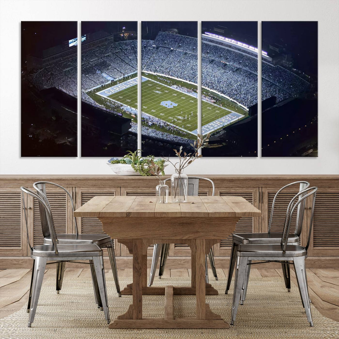 A University of North Carolina Tar Heels Football Team Print, showcasing Chapel Hill's Kenan Memorial Stadium, hangs in a modern dining room, adding a gallery-quality finish that enhances the entire space.