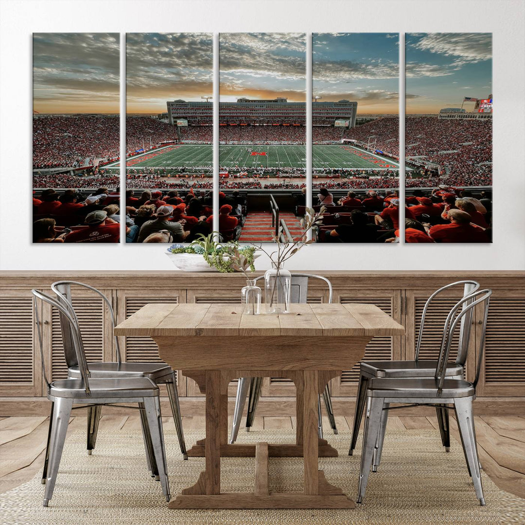 The living room features a stunning triptych of Lincoln Memorial Stadium wall art canvas print, celebrating the University of Nebraska Cornhuskers football team. This piece serves as captivating wall art, showcasing a gallery-quality finish.