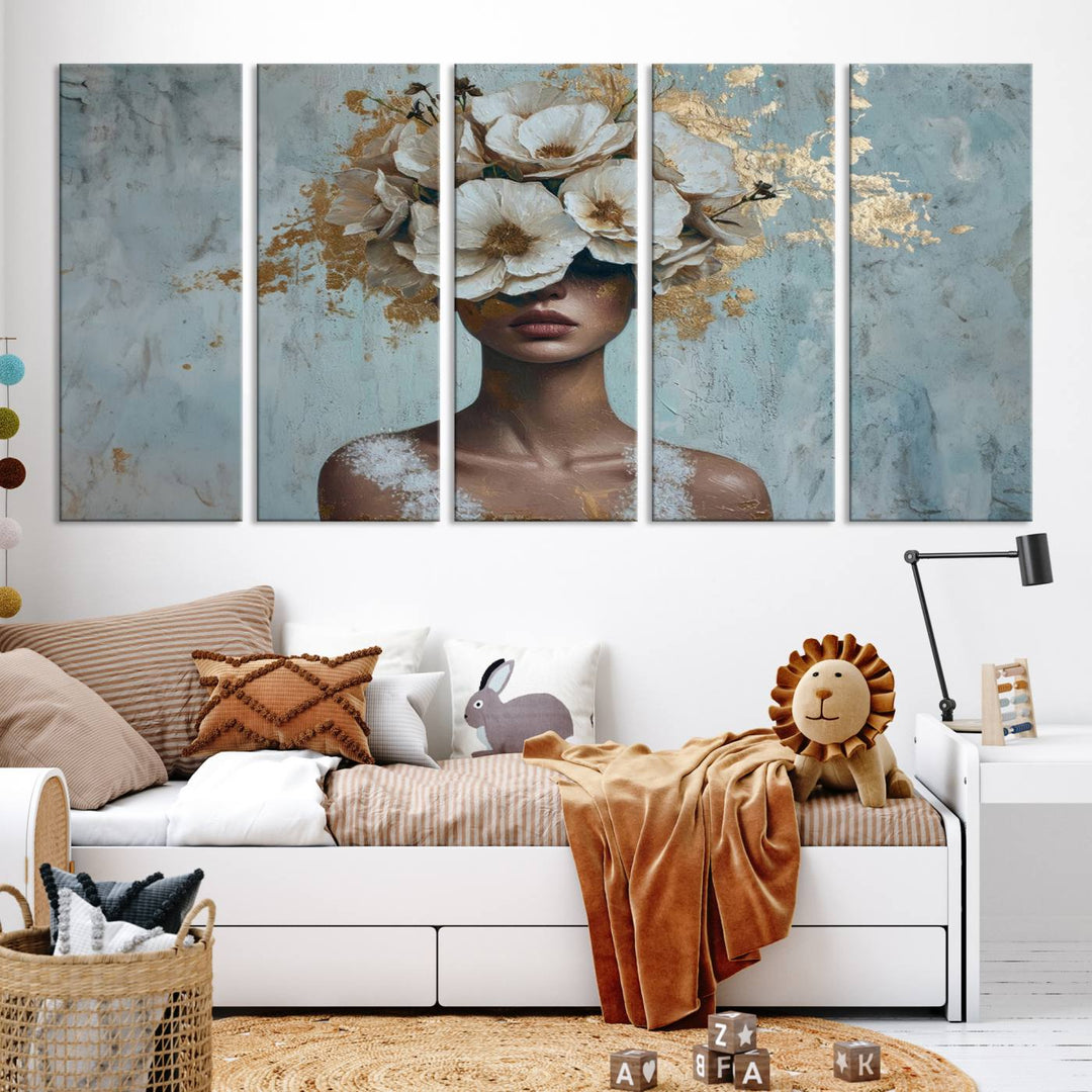 The Golden Petal Silhouette Woman Wall Art Canvas Print, a large 3-panel canvas with a textured gold floral design, serves as a luxurious centerpiece in modern glam settings. The artwork depicts a woman with flowers over her eyes against a textured background and hangs elegantly.