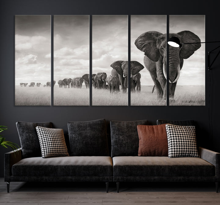 The "Herd of Elephants Wall Art Canvas Print" features an elegant black and white triptych of elephants walking in a line, beautifully displayed on museum-quality canvas with a UV-protective coating. This artwork arrives ready to hang and adds sophistication to any space.