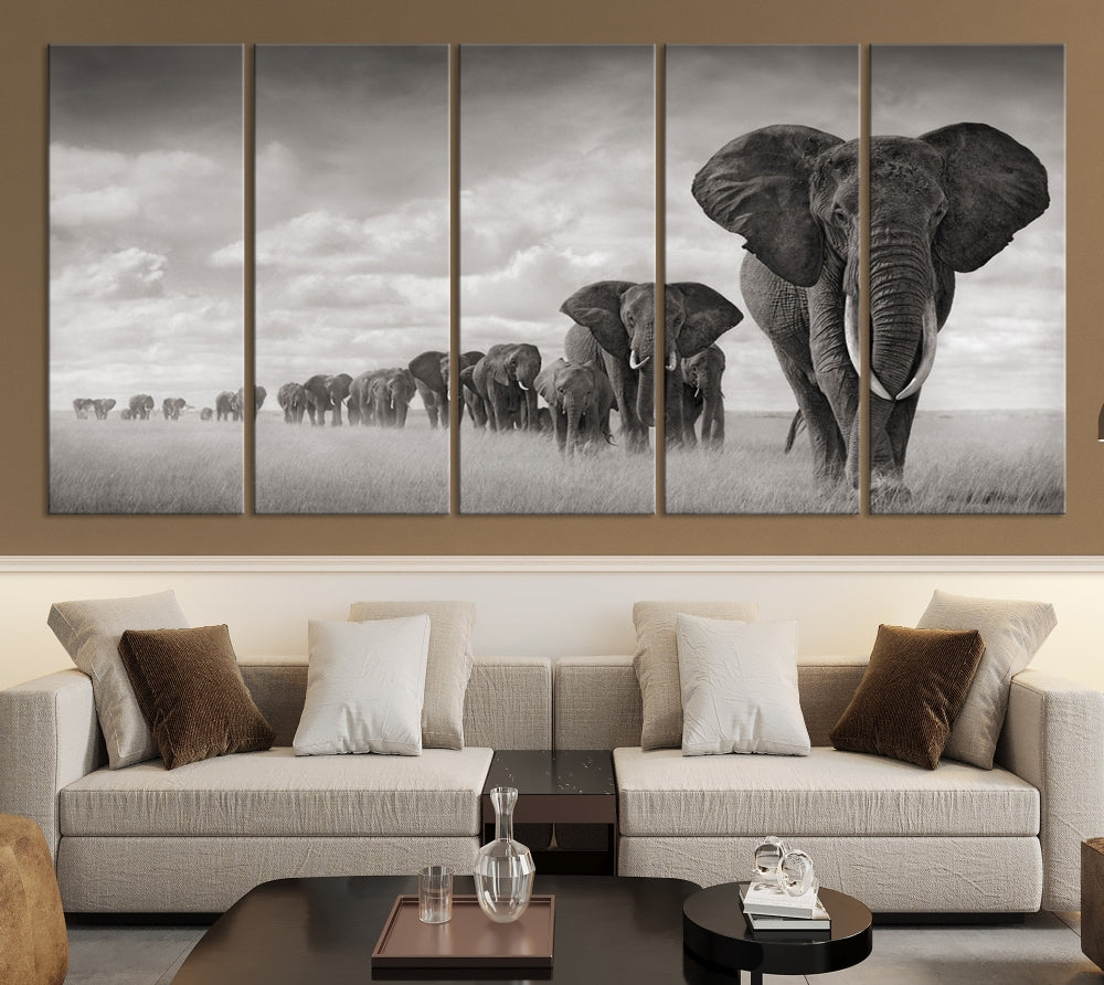 The Elephant Wall Art Canvas Print features a triptych of elephants in a savanna, elegantly displayed.