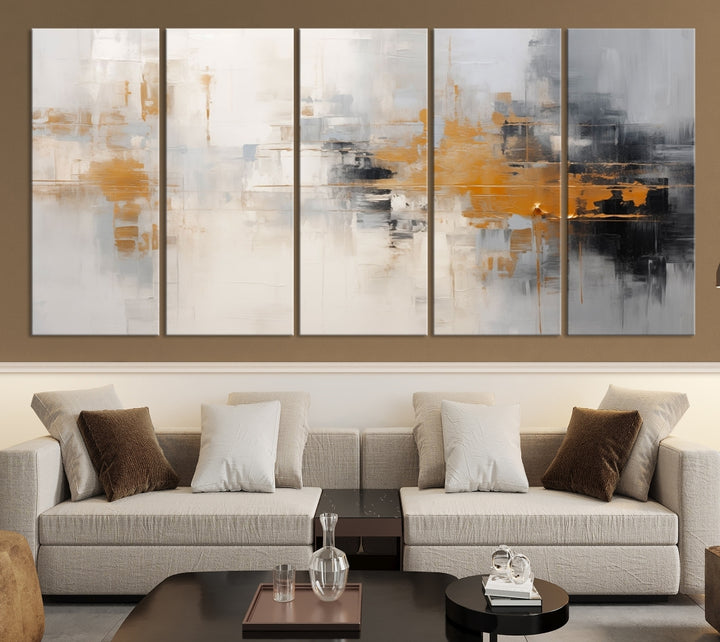 The Orange Pastel Abstract Wall Art Canvas Print, featuring a triptych of orange, white, and black hues, is elegantly displayed on museum-quality canvas.