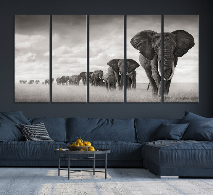 The "Herd of Elephants Wall Art Canvas Print" features an elegant black and white triptych of elephants walking in a line, beautifully displayed on museum-quality canvas with a UV-protective coating. This artwork arrives ready to hang and adds sophistication to any space.