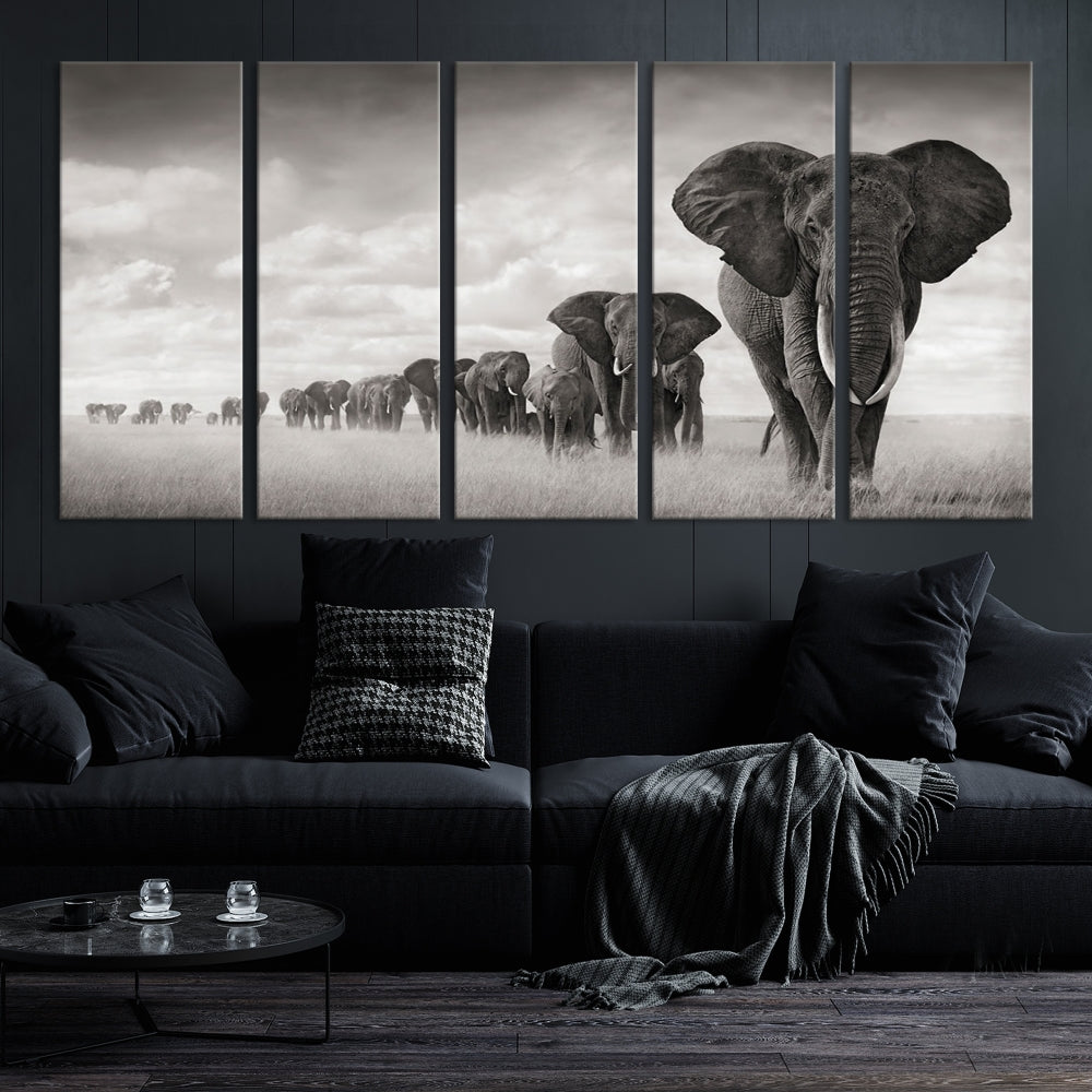 The "Herd of Elephants Wall Art Canvas Print" features an elegant black and white triptych of elephants walking in a line, beautifully displayed on museum-quality canvas with a UV-protective coating. This artwork arrives ready to hang and adds sophistication to any space.