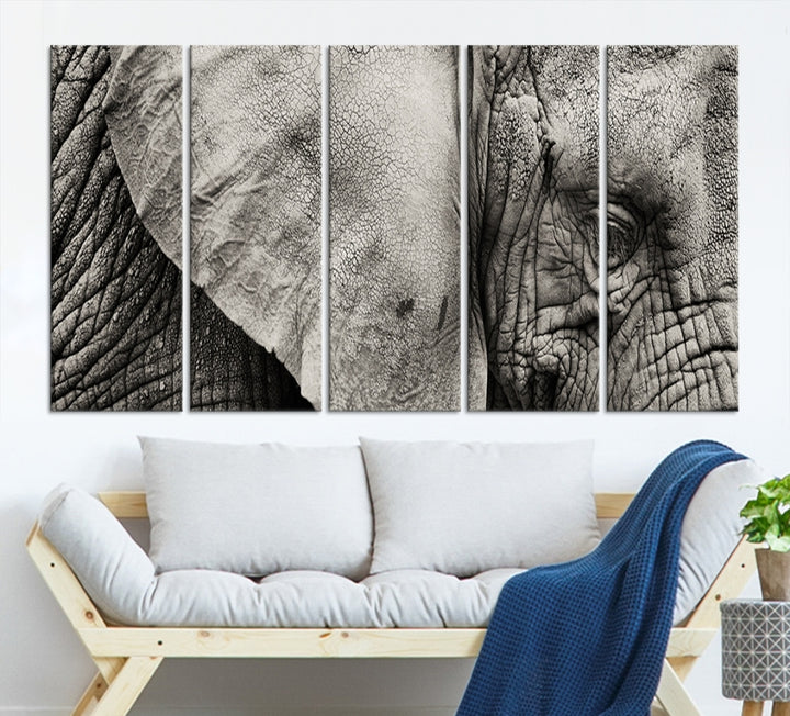 A modern living room features a large Elephant Wall Art Canvas Print in black and white, crafted on museum-quality canvases with UV-protective coating to maintain its elegance.