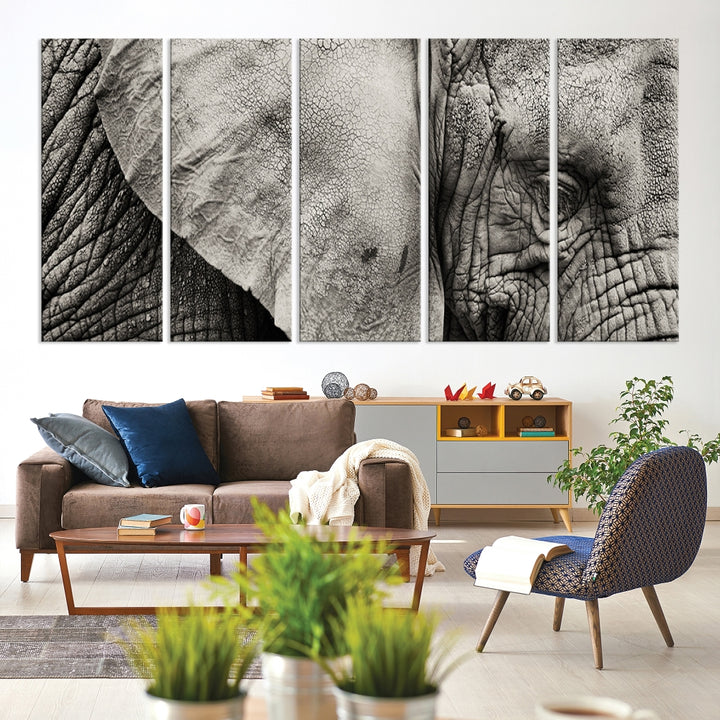 A modern living room features a large Elephant Wall Art Canvas Print in black and white, crafted on museum-quality canvases with UV-protective coating to maintain its elegance.