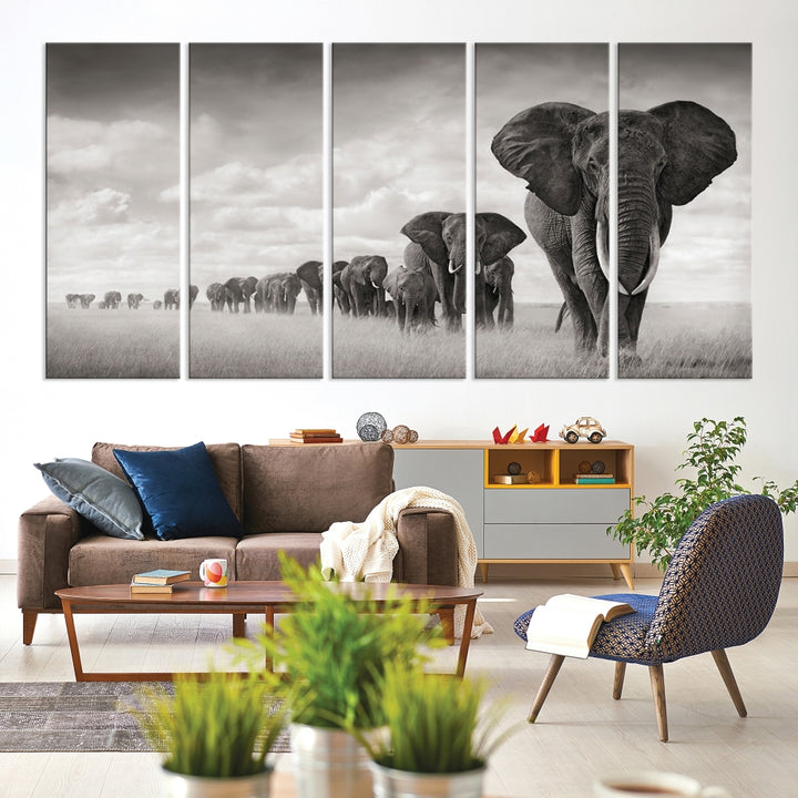 The "Herd of Elephants Wall Art Canvas Print" features an elegant black and white triptych of elephants walking in a line, beautifully displayed on museum-quality canvas with a UV-protective coating. This artwork arrives ready to hang and adds sophistication to any space.