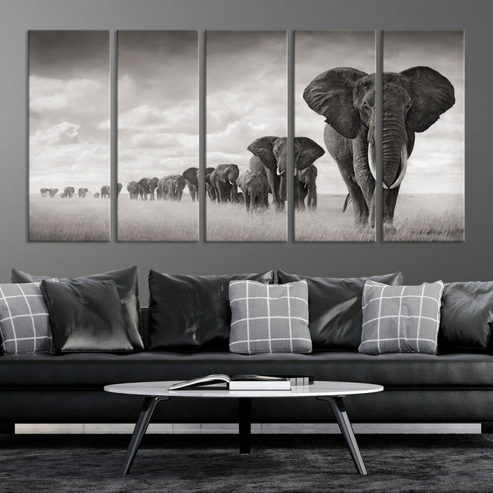 The "Herd of Elephants Wall Art Canvas Print" features an elegant black and white triptych of elephants walking in a line, beautifully displayed on museum-quality canvas with a UV-protective coating. This artwork arrives ready to hang and adds sophistication to any space.