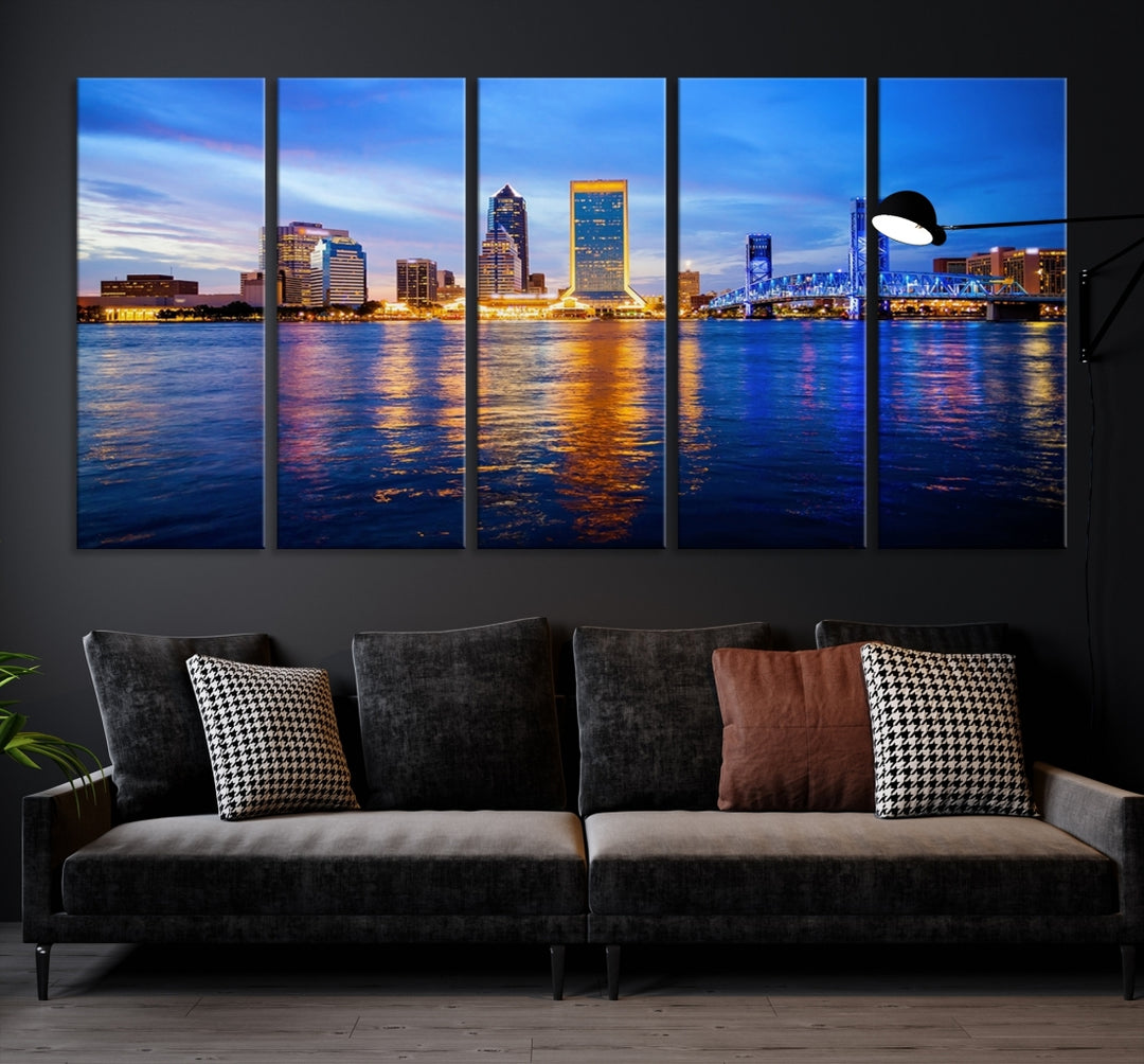 A cozy living room features the Jacksonville Wall Art Canvas Print, a large triptych crafted on museum-quality canvas that beautifully depicts the Jacksonville city skyline at sunset.