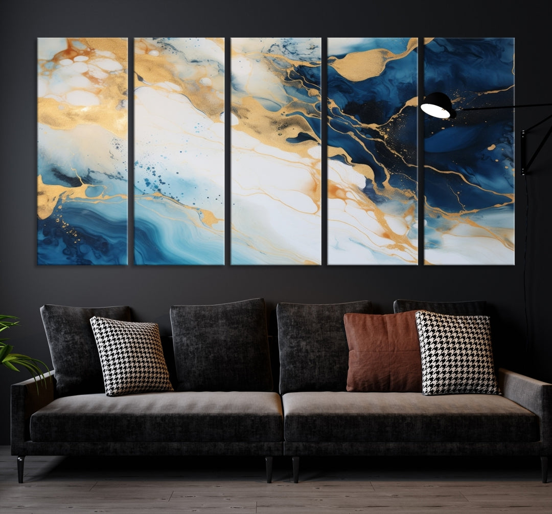 A modern living room featuring museum-quality Blue Gold Abstract Wall Art Print Contemporary art in a triptych arrangement.