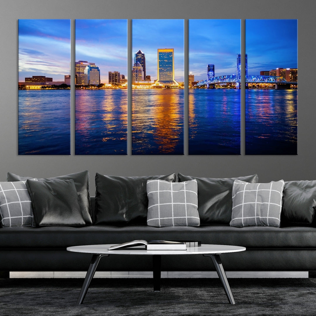 A cozy living room features the Jacksonville Wall Art Canvas Print, a large triptych crafted on museum-quality canvas that beautifully depicts the Jacksonville city skyline at sunset.