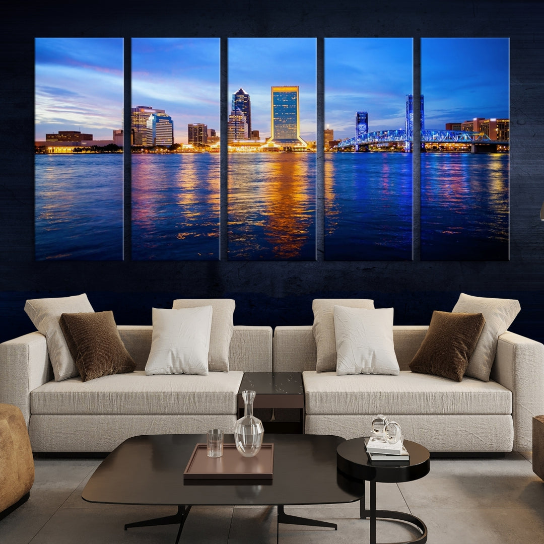 A cozy living room features the Jacksonville Wall Art Canvas Print, a large triptych crafted on museum-quality canvas that beautifully depicts the Jacksonville city skyline at sunset.