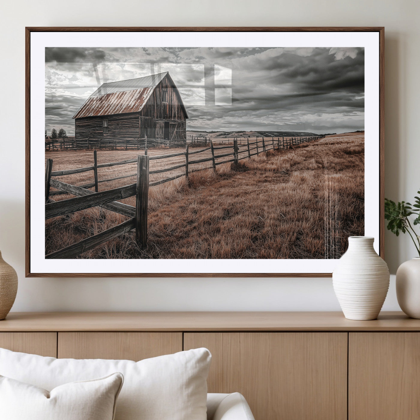 Framed canvas of a rustic barn under a moody sky with weathered fence and dark fields, ideal for farmhouse or rural-style wall decor.