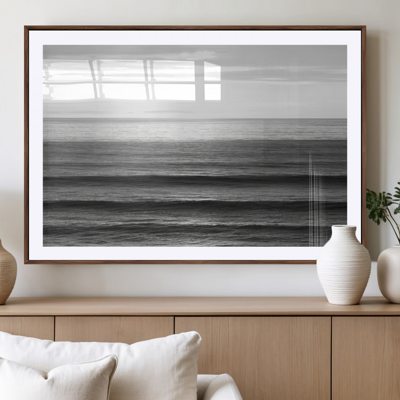 Minimalist black and white ocean view with layered waves reflecting sunlight, evoking a sense of calm and coastal serenity.