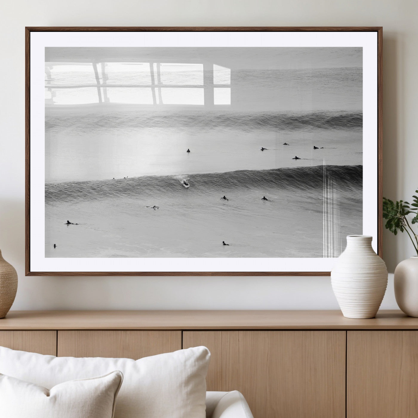 A monochrome photograph of swimmers gliding through gentle ocean waves, evoking a sense of calm and movement.
