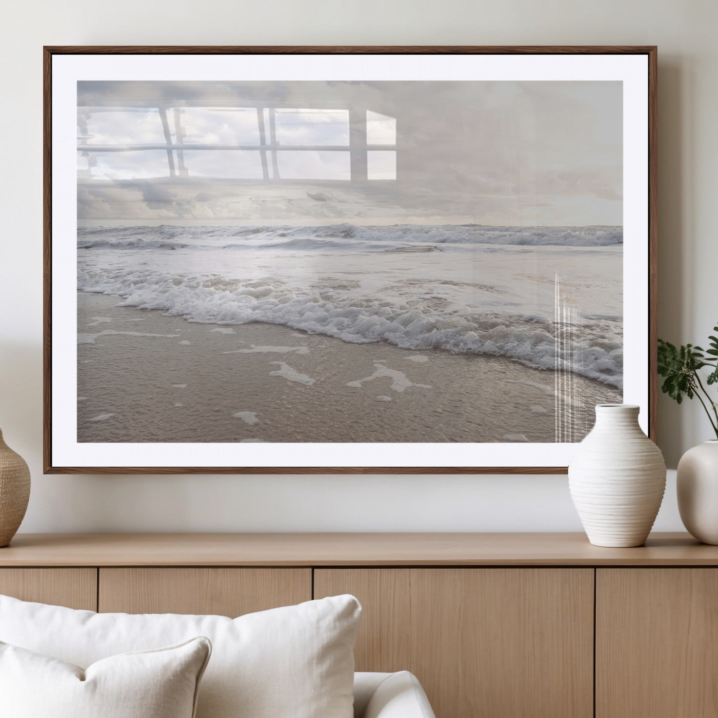 Peaceful ocean waves rolling onto the sandy shore under soft light, perfect for neutral or coastal minimalist decor themes.