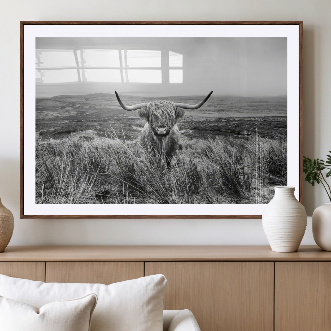 A black and white portrait of a Highland cow in a foggy Scottish countryside, capturing a rustic aesthetic and tranquil farm escape.