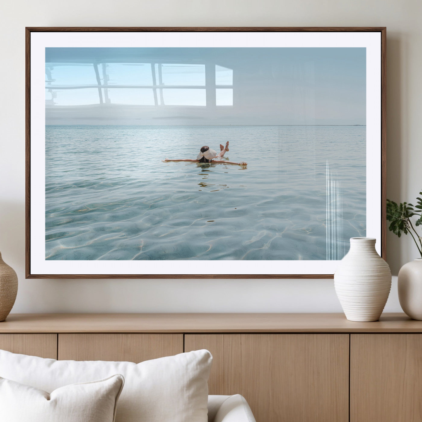 A peaceful minimalist scene of a person floating on crystal-clear water, surrounded by a vast open horizon, capturing relaxation and serenity in a tranquil aquatic setting.
