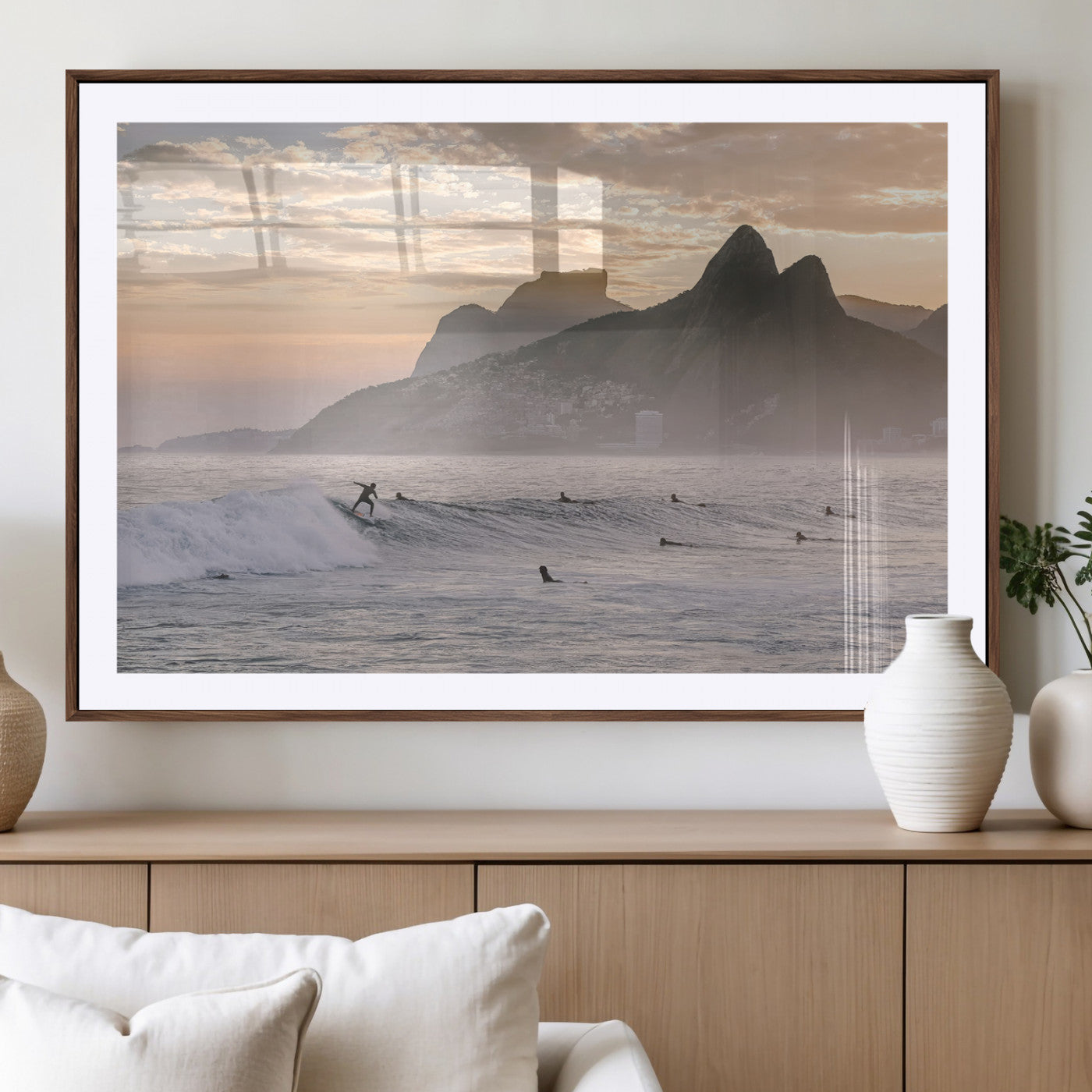 A surfer rides a golden hour wave near misty coastal mountains, surrounded by fellow surfers, capturing the spirit of a coastal adventure.
