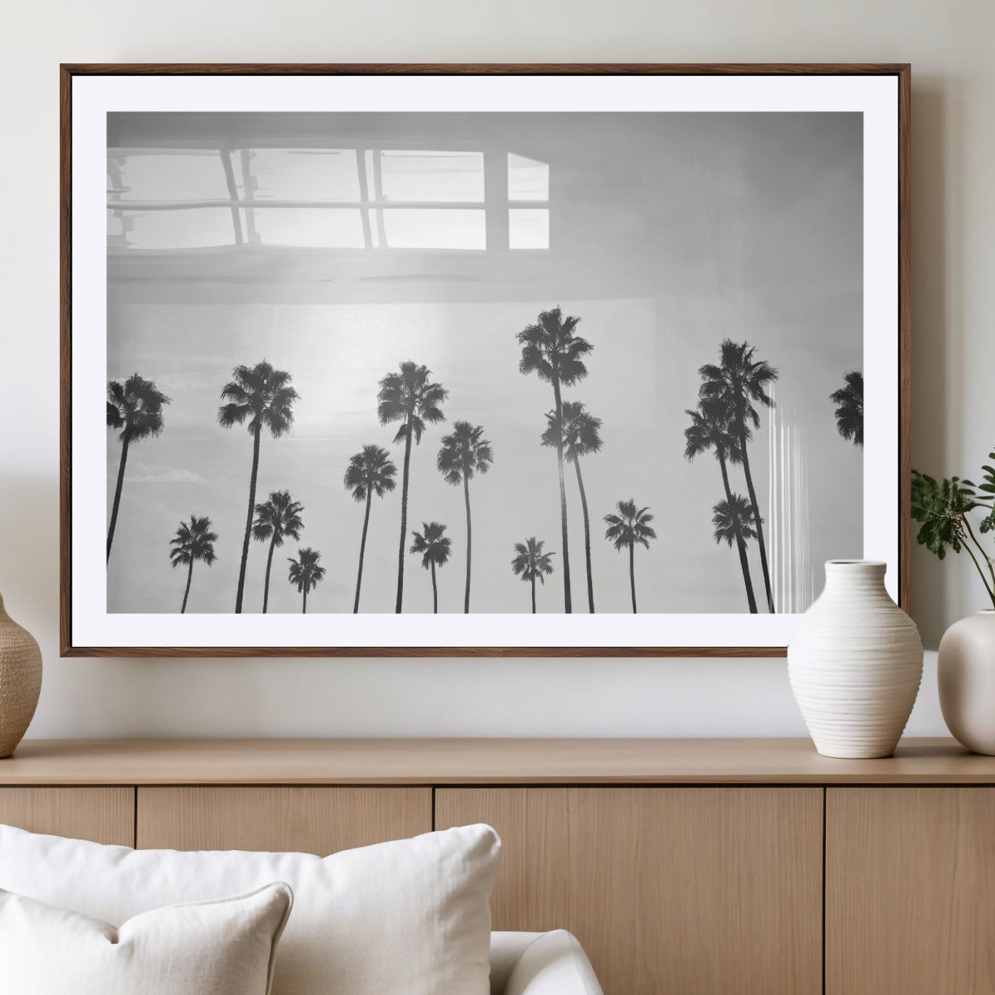 A black and white minimalist scene featuring tall palm trees silhouetted against a bright sky, creating a dreamy and timeless tropical aesthetic.