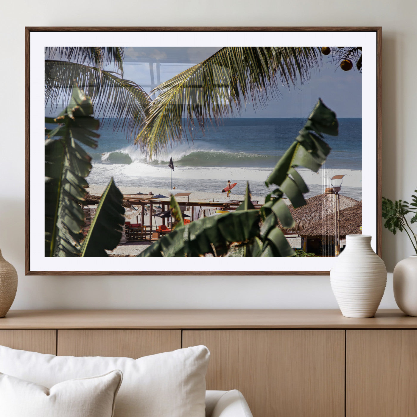 Canvas wall art of a tropical surf scene framed by palm trees, with a surfer on the shore and waves rolling in, ideal for beach-themed decor.