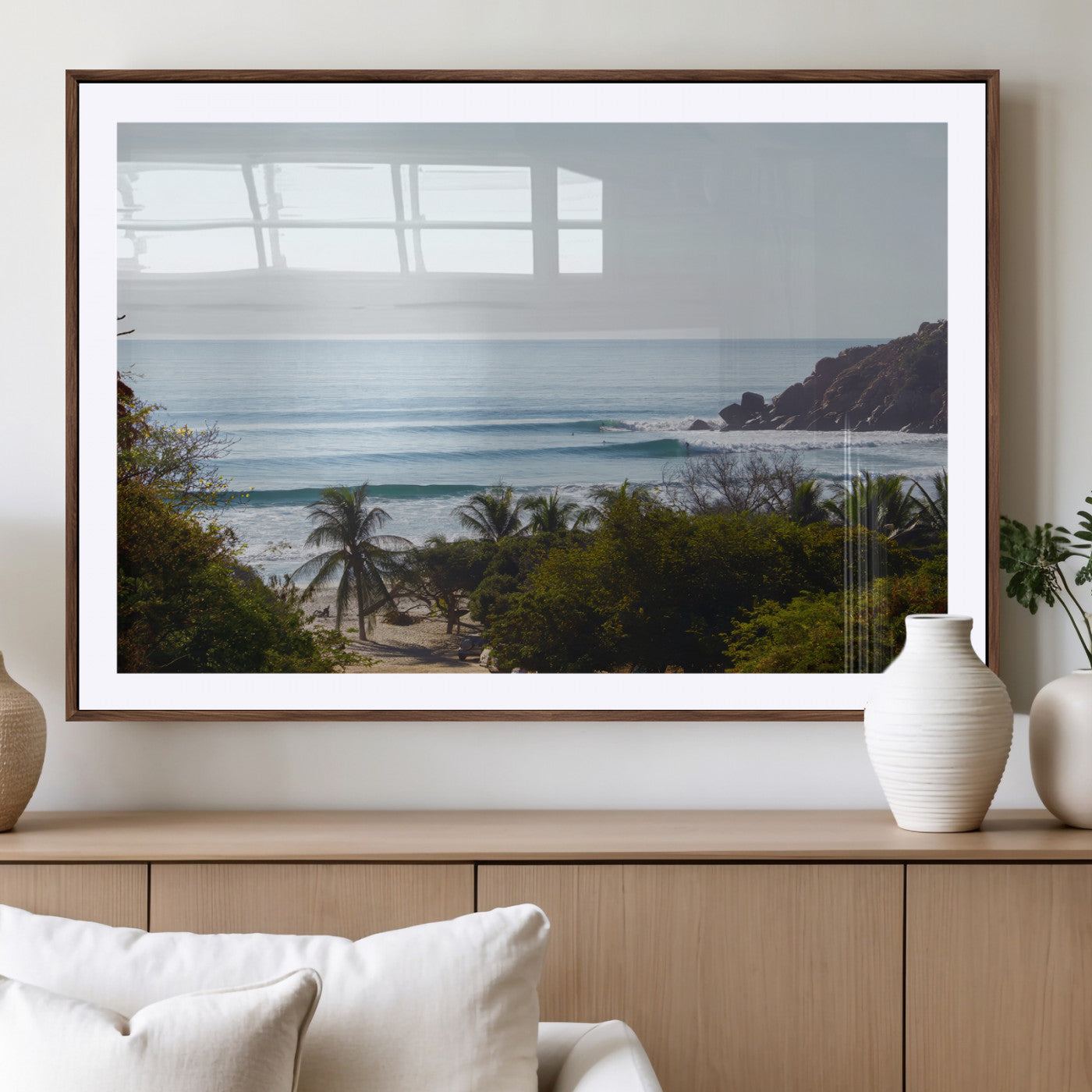 View of calm ocean waves with palm trees and a tropical coastline, ideal for coastal boho or beach-themed wall decor.