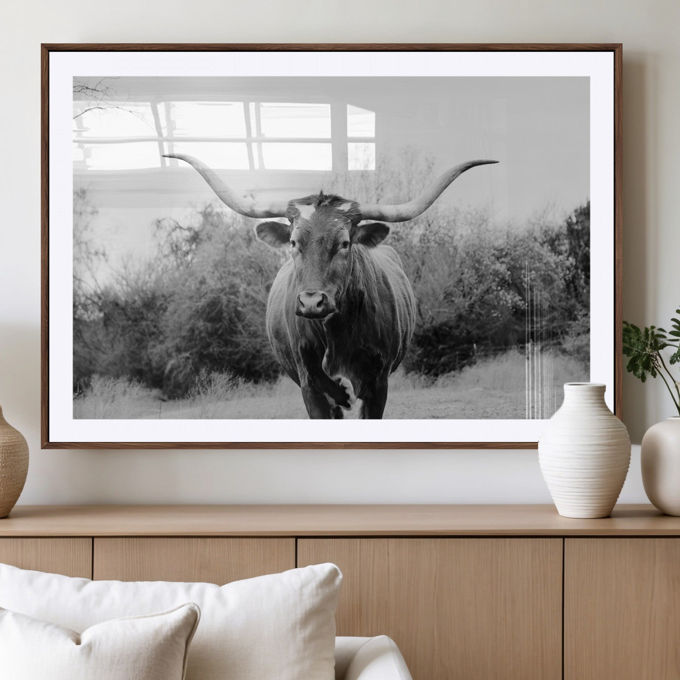 Black and white photo of a Longhorn cow facing camera, ideal for rustic, farmhouse, or western-themed home wall decor.