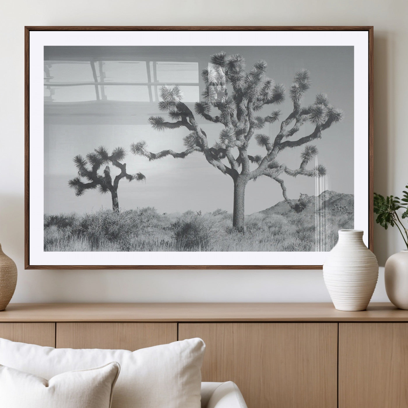 Two Joshua trees in a black and white desert landscape with distant hills, ideal for boho or rustic interior wall styling.
