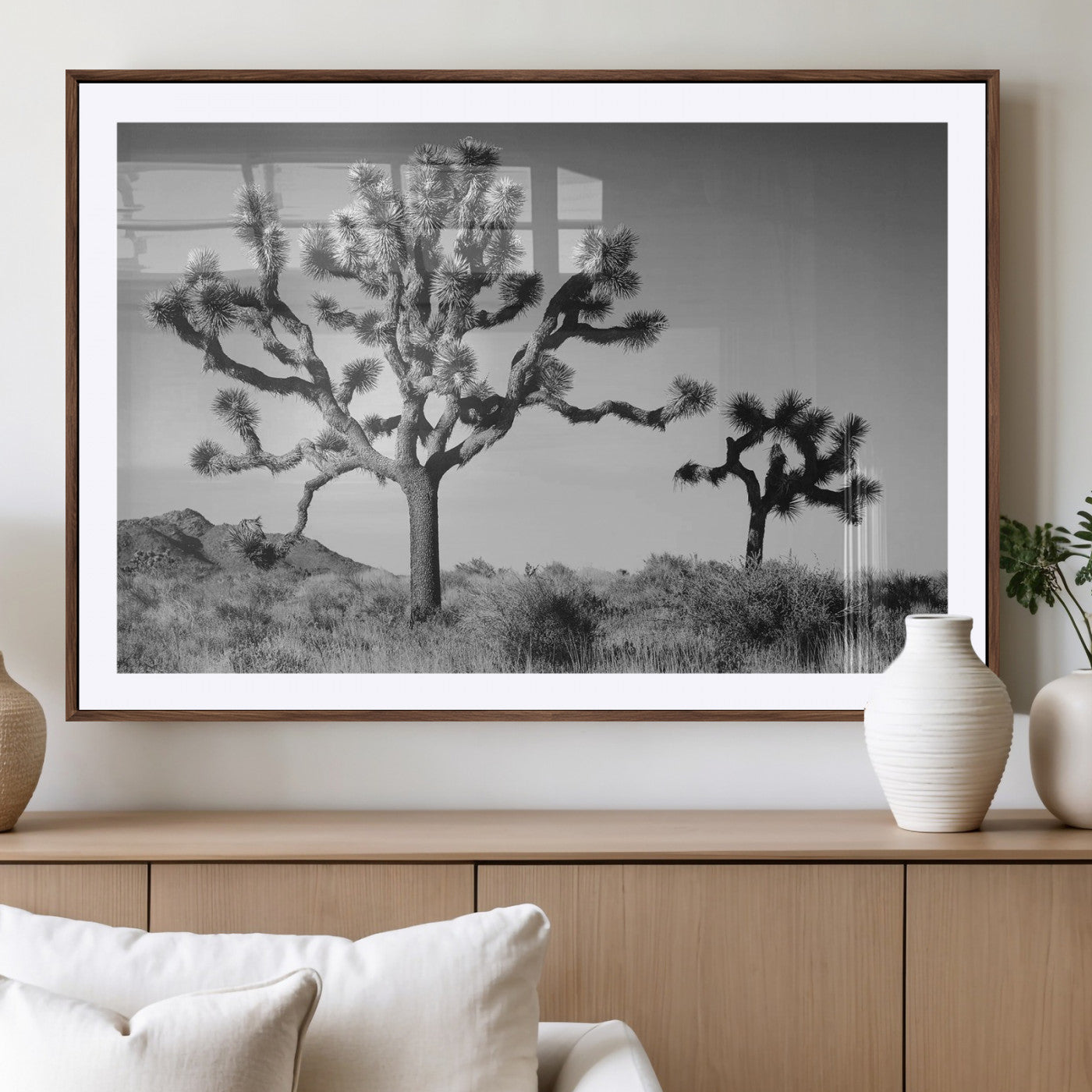 Black and white desert scene with two Joshua trees under clear sky, perfect for rustic or boho-inspired home decor.