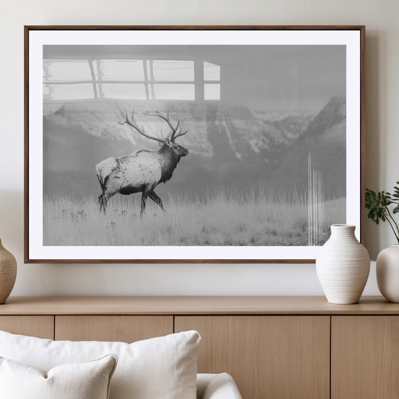 Black and white elk standing in front of snowy mountain range, perfect for rustic lodge or nature-inspired wall decor.