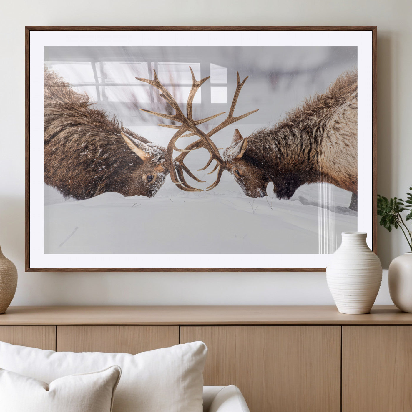 Two elk clashing antlers in a snowy forest, capturing raw power and wild energy, ideal for rustic cabin or lodge-style decor.