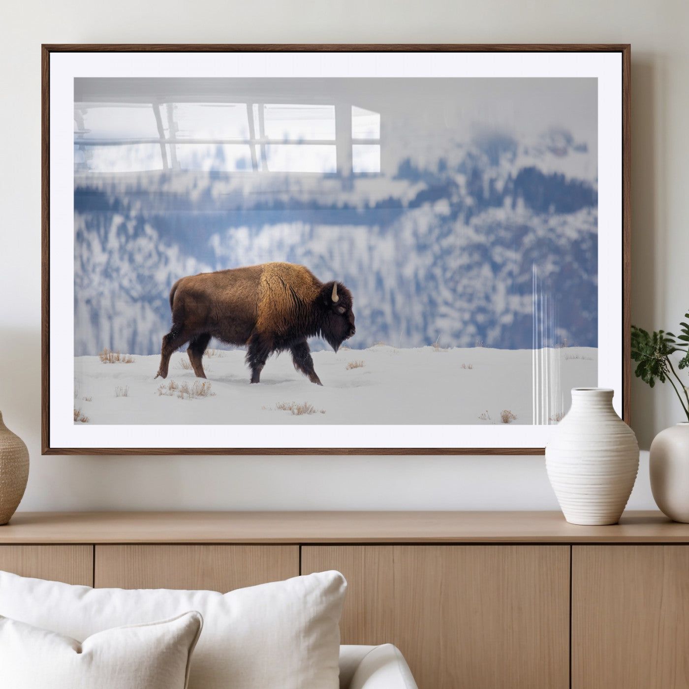 A lone bison walks across snowy ground with blue-toned mountain range behind, ideal for rustic or western farmhouse interiors.
