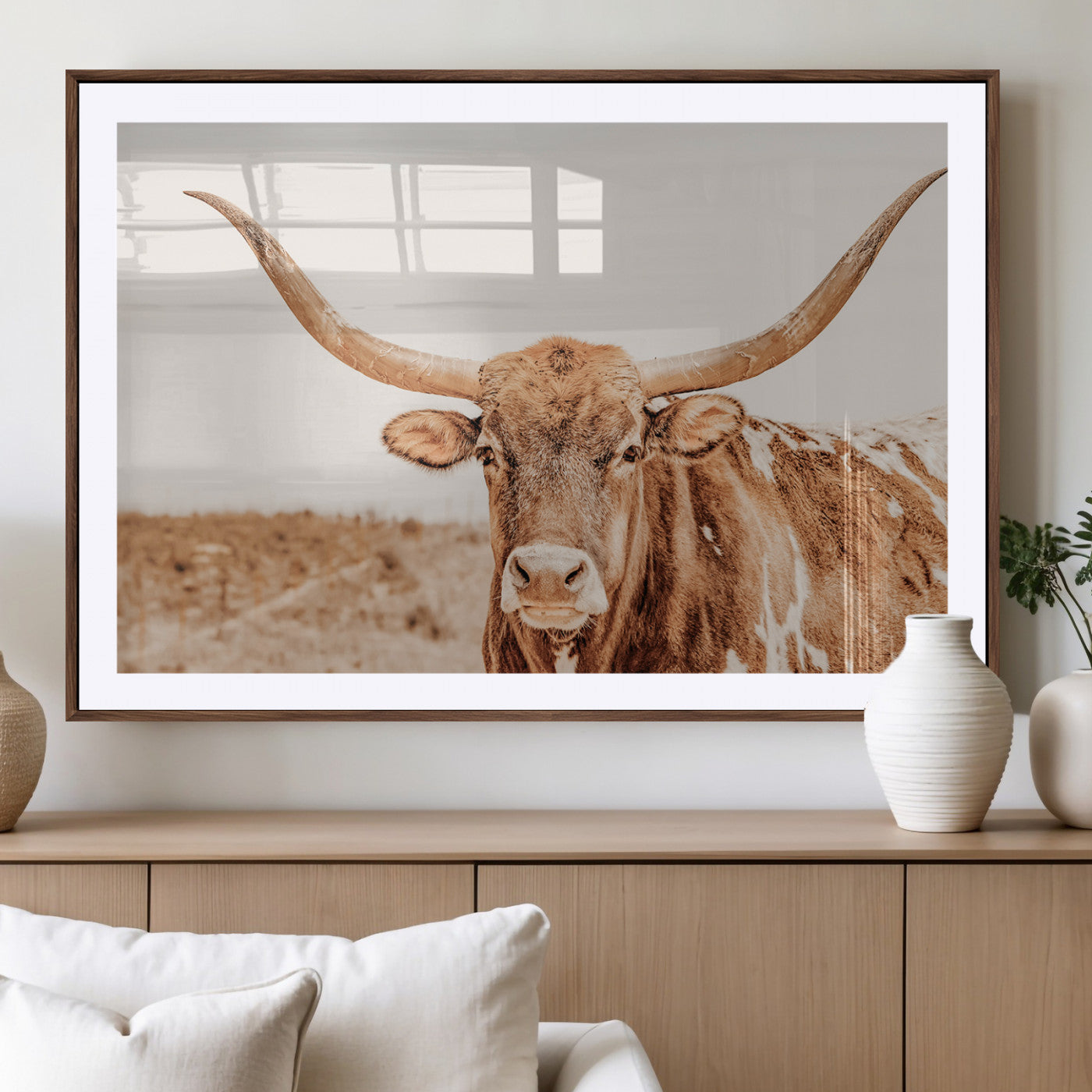 A longhorn bull standing proudly in a sunlit desert field with warm neutral tones, ideal for rustic western or farmhouse interiors.