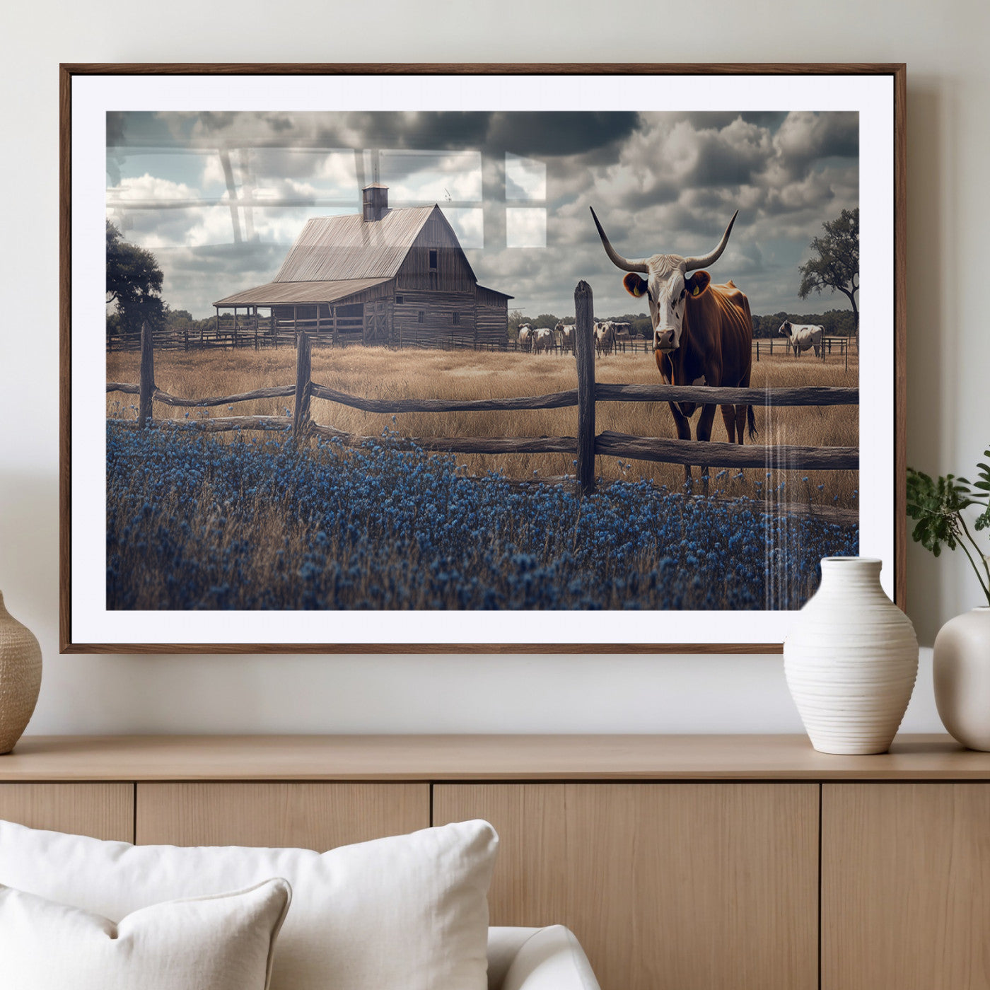 Framed canvas art of a Texas Longhorn cow near a rustic barn and bluebonnet field, ideal for country-style or farmhouse wall decor.