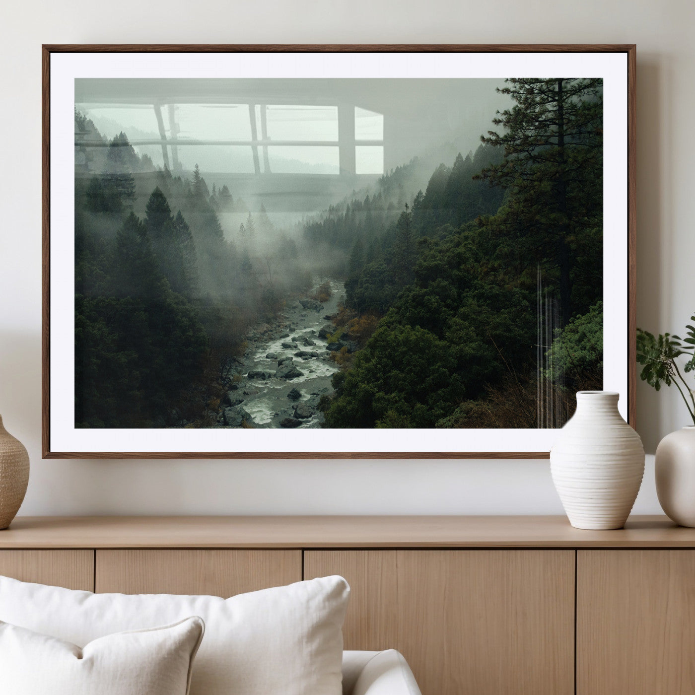 Misty forest with a winding river flowing through lush green mountains, creating a tranquil and moody wilderness landscape.