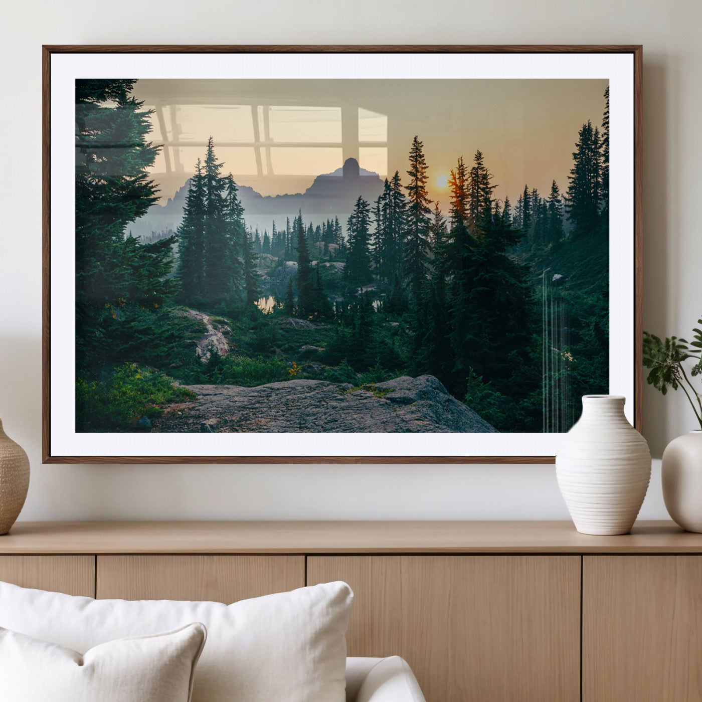 Mountain landscape with evergreen trees at sunset, casting a golden glow over the wilderness, creating a peaceful and rustic nature scene.