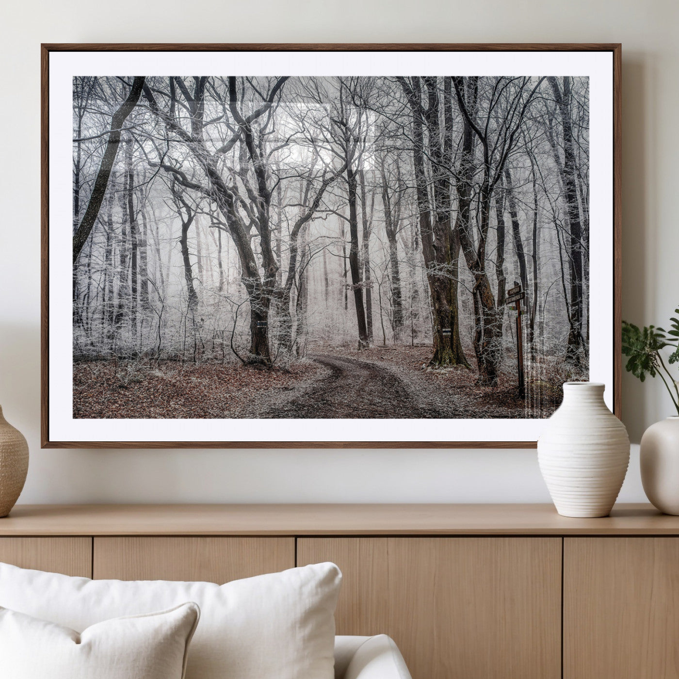 Snow-covered trees in a misty winter forest with a winding path, creating a serene and mysterious atmosphere, perfect for nature-inspired wall art.