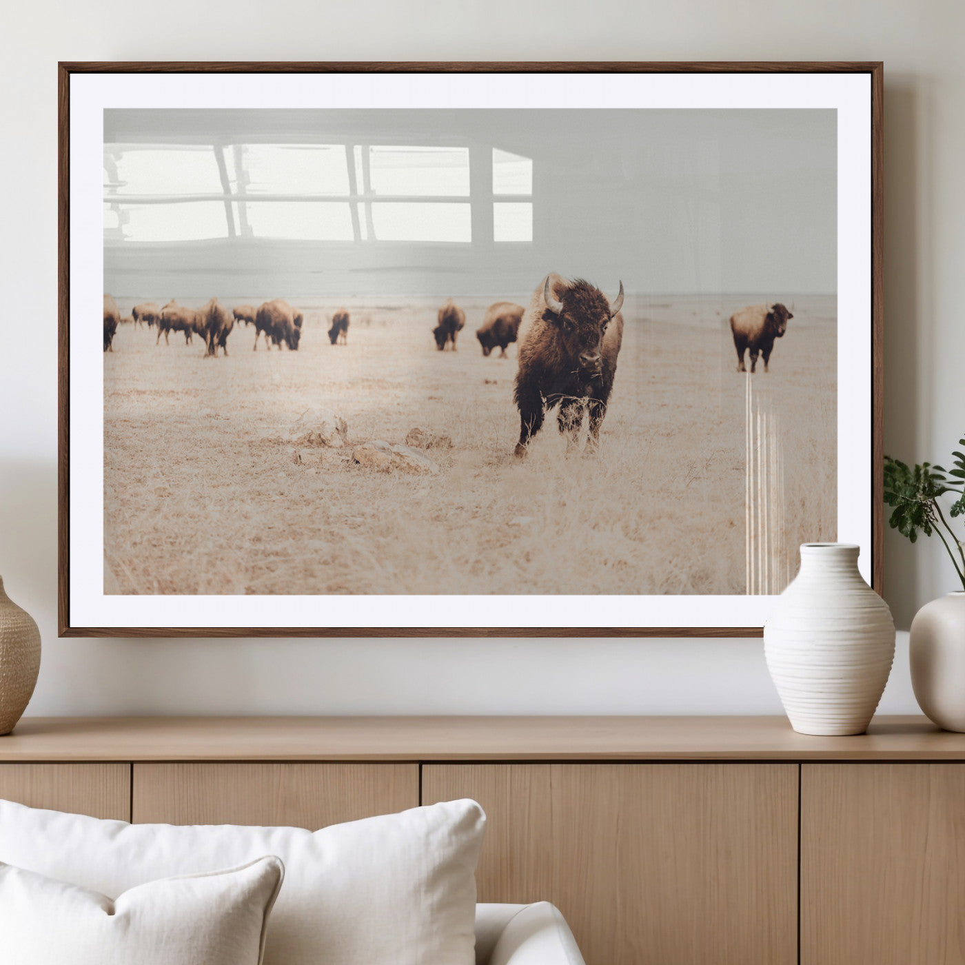 Herd of bison roaming a vast prairie with golden grass under a soft sky, creating a rustic and Western landscape, ideal for wall art.