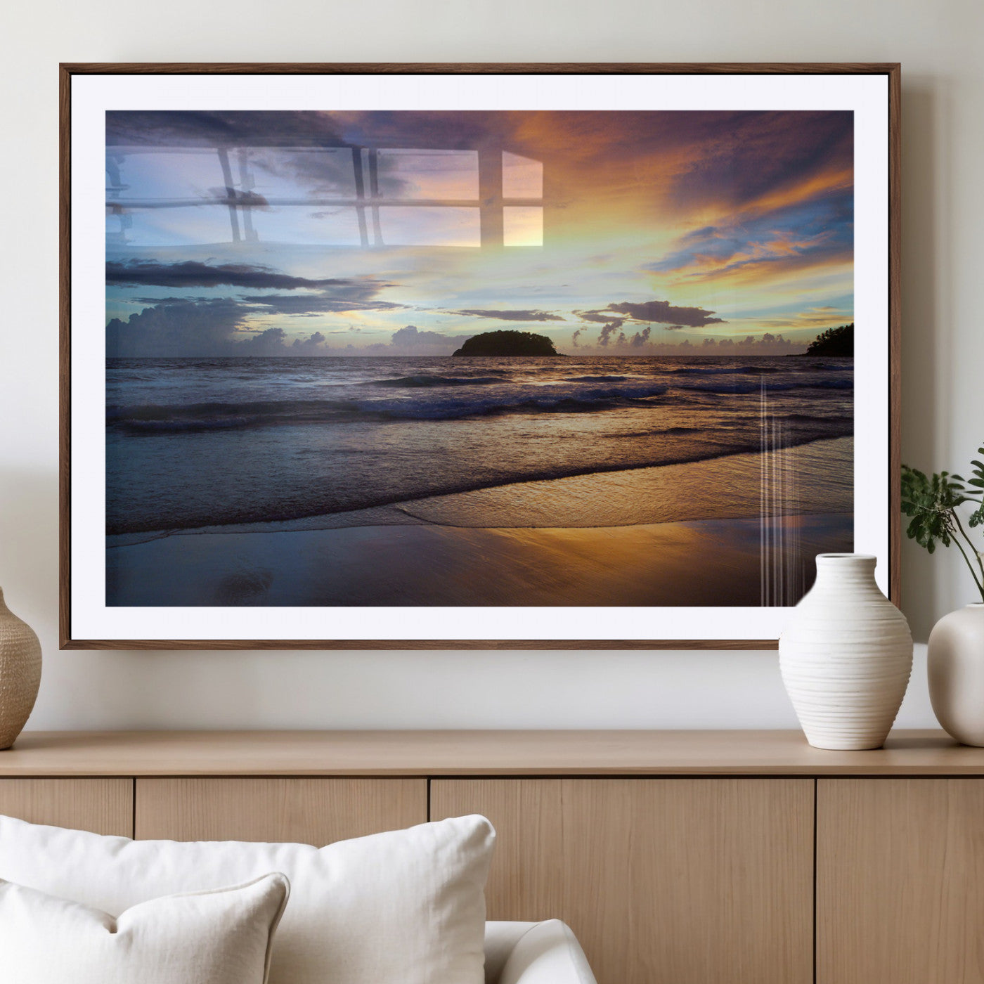 A tropical beach at sunset with waves gently washing ashore, reflecting golden and purple hues in the sky, creating a tranquil coastal scene.