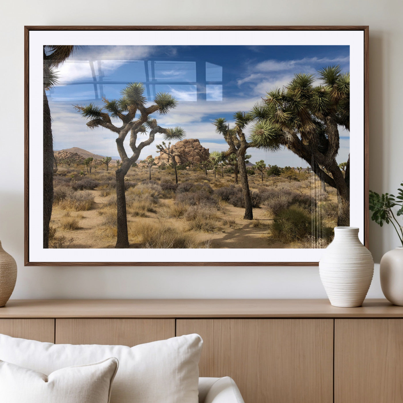 Scenic Joshua Tree landscape with rugged desert terrain, golden dry grass, and a deep blue sky, creating a warm, rustic Southwestern aesthetic.