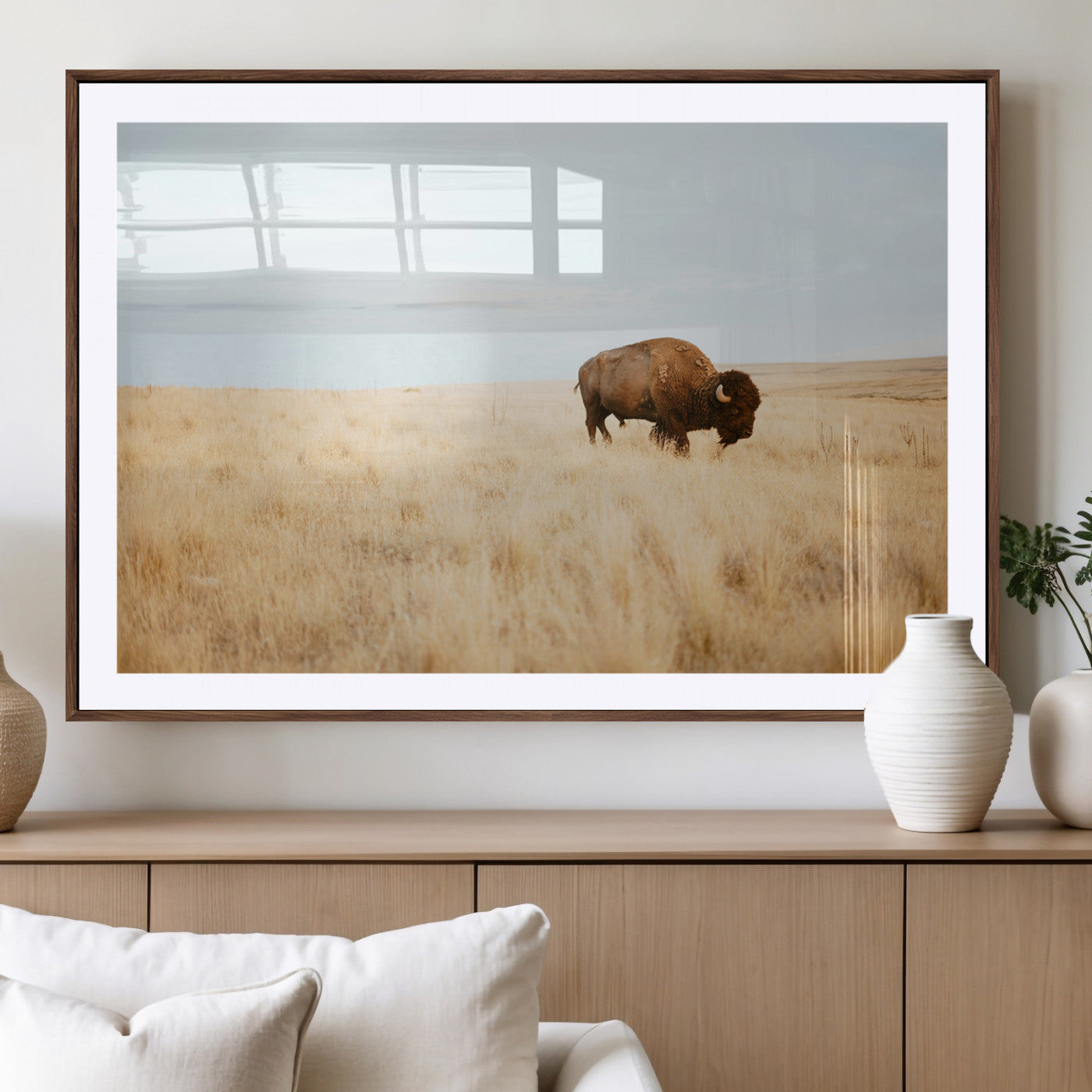 A lone bison standing in a vast golden grassland under a soft blue sky, evoking a rustic and Western aesthetic, ideal for farmhouse decor.