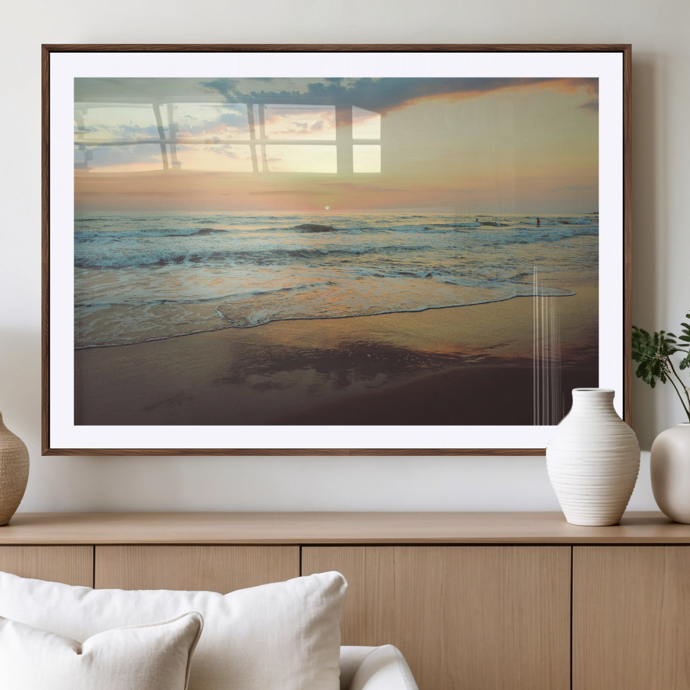 Warm sunset over gentle ocean waves with pastel sky and reflections on wet sand, creating a calm and soothing beach ambiance.