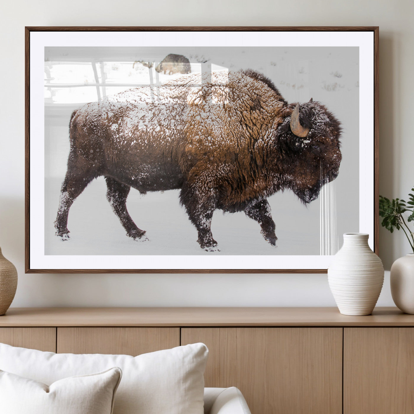 Side profile of a powerful bison walking through deep snow, with frost-covered fur and a white winter background, perfect for rustic and western decor.