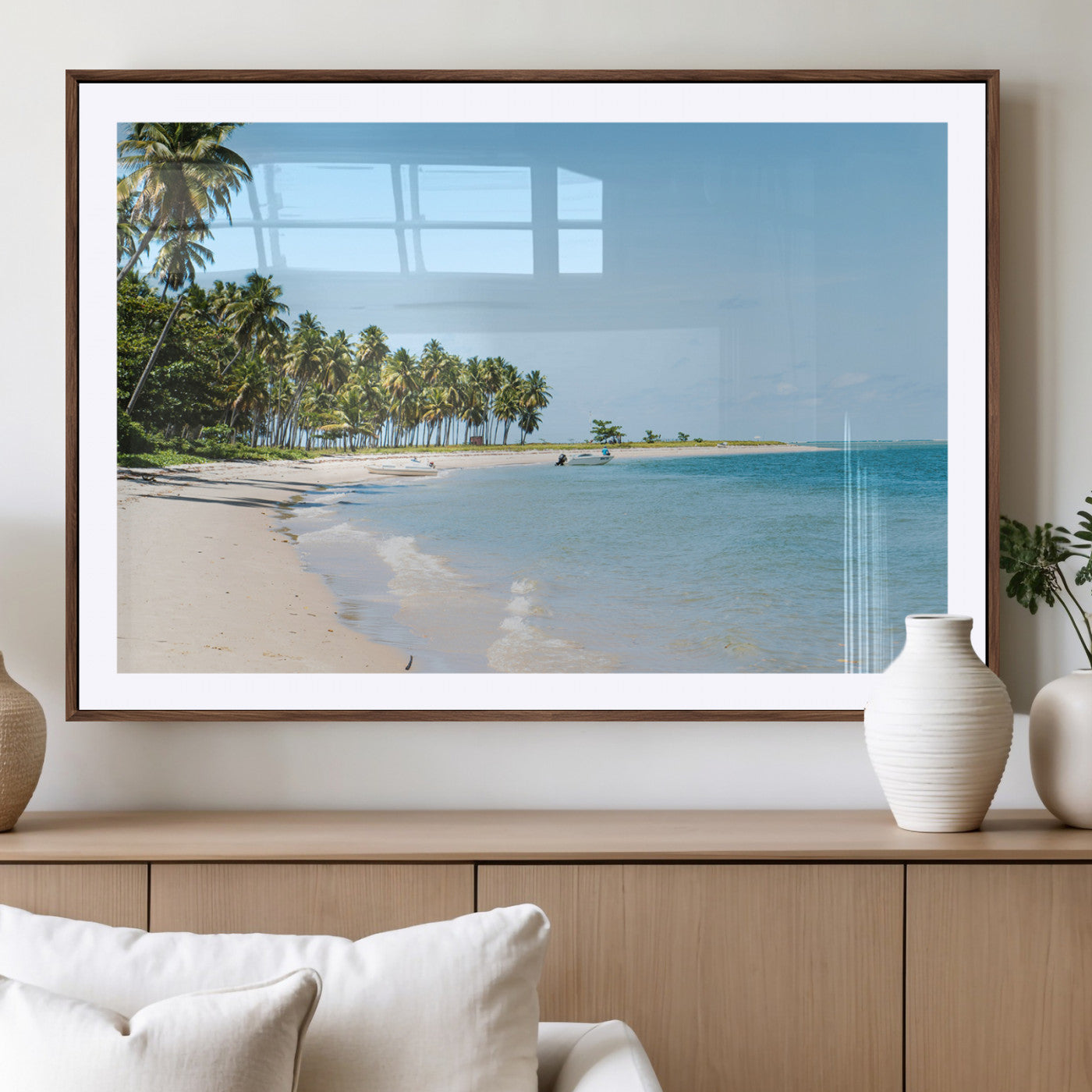 A serene tropical beach with clear blue water, soft sand, and lush palm trees under a bright sky, creating a peaceful island paradise atmosphere.